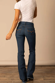 Kimes Ranch Lola Raw Hem Wide Flare Leg Jeans worn over cowgirl boots