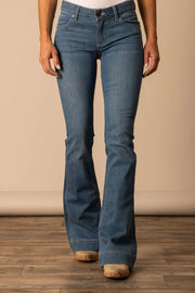 Kimes Ranch Lola Soho Fade Mid-Rise Jeans worn over cowgirl boots